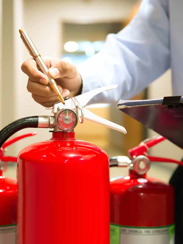 Fire Extinguisher Technician Testing Pressure Gauges